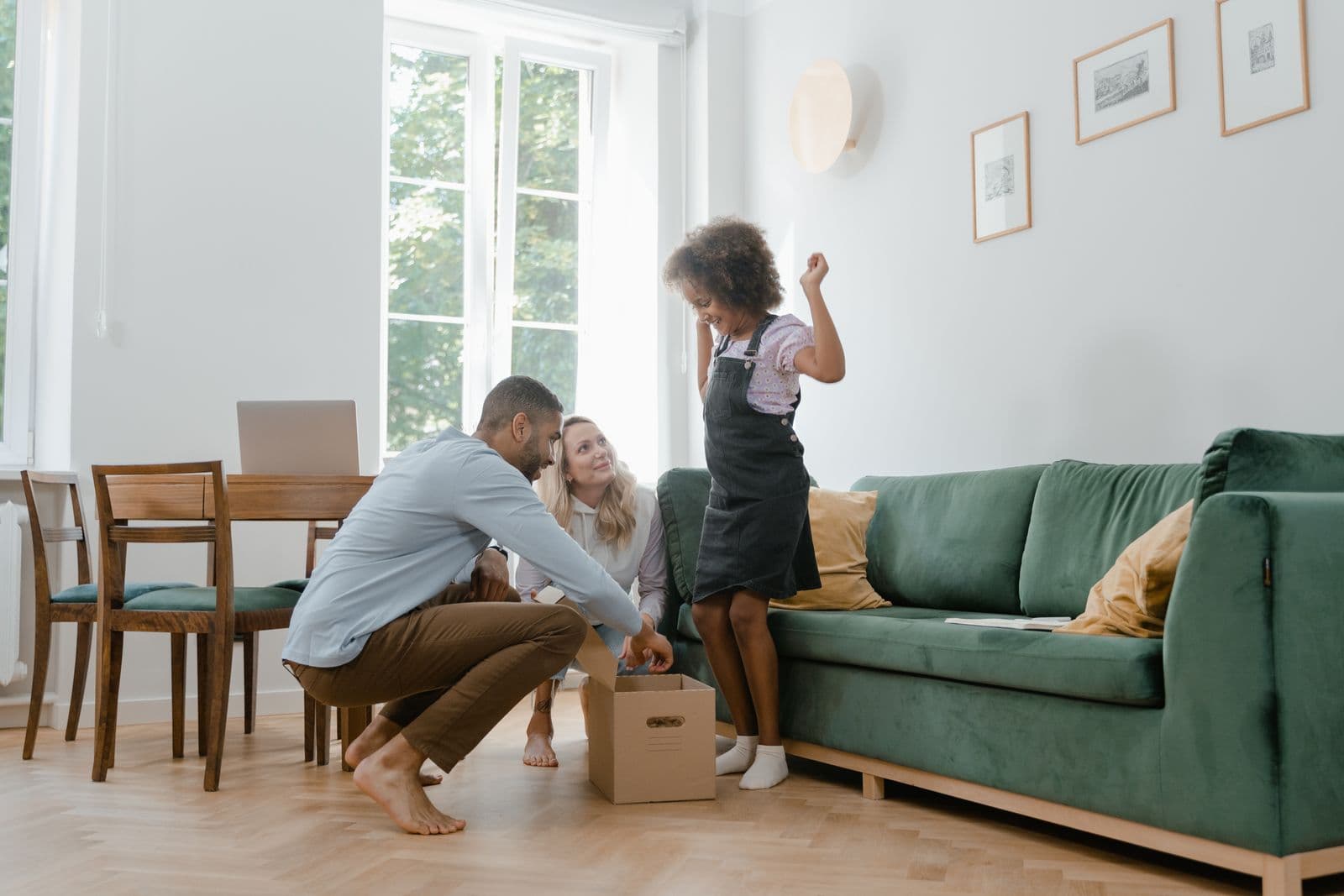 Family unpacking boxes together in their new living room